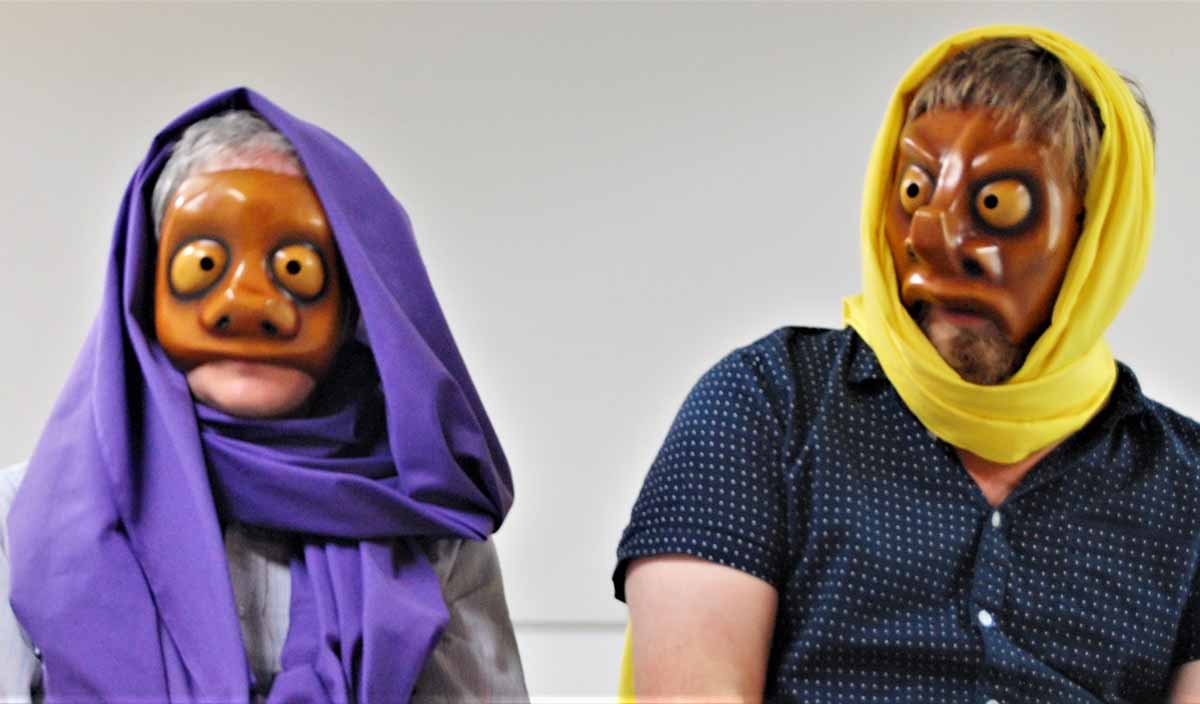 man and woman improvisers wear masks