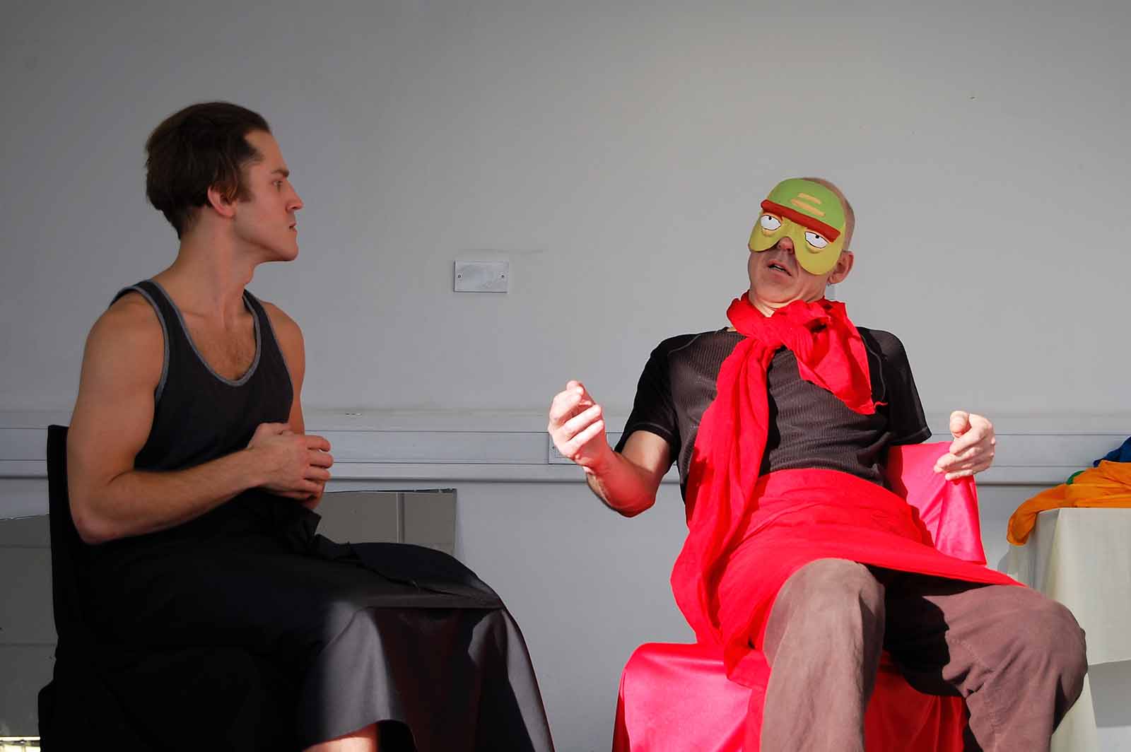 Two men on stage during a Zootrophic improv rehearsal in London, 2016, focusing on their characters' statuses